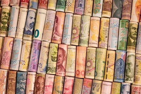Different banknotes from various countries on rolls Stock Photos
