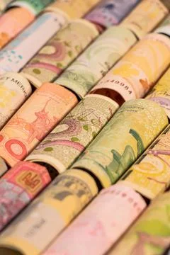 Different banknotes from various countries on rolls Stock Photos