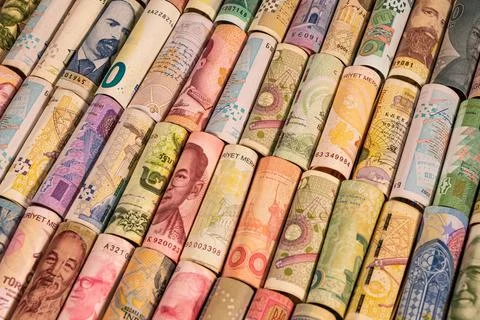 Different banknotes from various countries on rolls Stock Photos