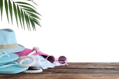 Different beach objects on wooden table against white background. Space for t Stock Photos