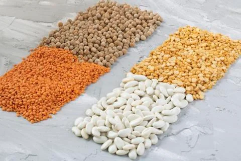 Different beans, peas, lentils on grey table, top view food Stock Photos