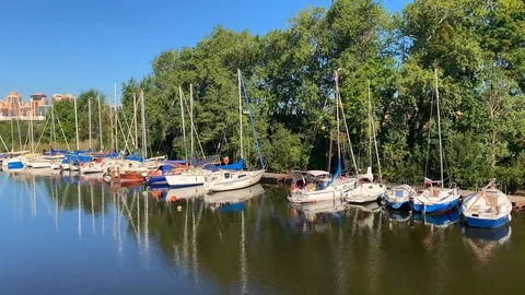 Different beautiful small yachts stand at the pier Stock Footage 115964390