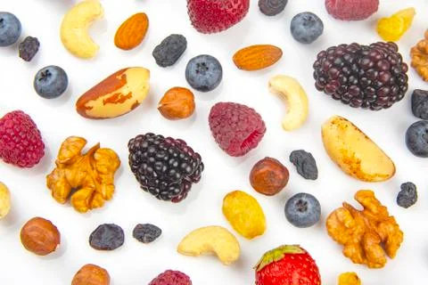 Different berries and nuts on a white background. vitamin proteins and health Stock Photos