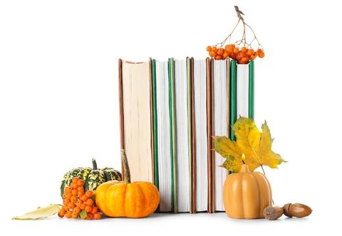 Different books with burning candle, pumpkins, rowan berries, acorns and autu Stock Photos