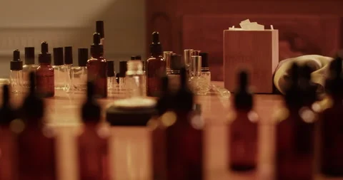 Different bottles placed on table in perfume lab Video stock 260984125