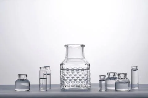 Different bottles of water on a light background. It can fit the theme of Stock Photos
