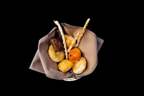 Different bread in the basket. Top view. Isolated on a black background Stock Photos