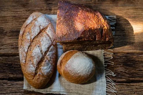 Different bread rye round baguette isolated on wood Stock Photos