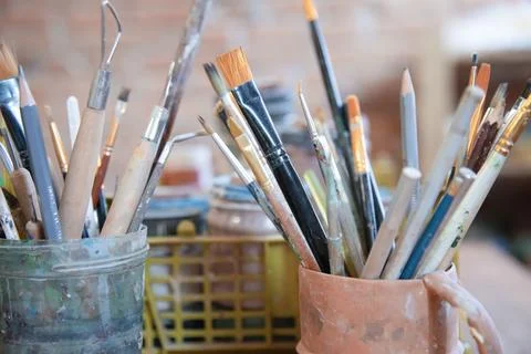 Different brushes in drawing studio interior. Close up view Stock Photos