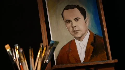 Different brushes, rotation, with easel and painting man in brown jacket Stock Footage 49709771