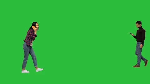Different casual people walking by on a Green Screen, Chroma Key. Stock Footage