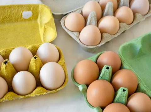 Different categories of eggs in trays on table. top view Stock Photos