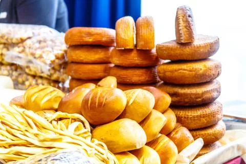 Different cheeses and bread are on the shelves Stock Photos