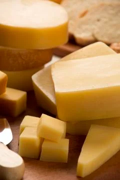 Different cheeses on a cutting board. Stock Photos