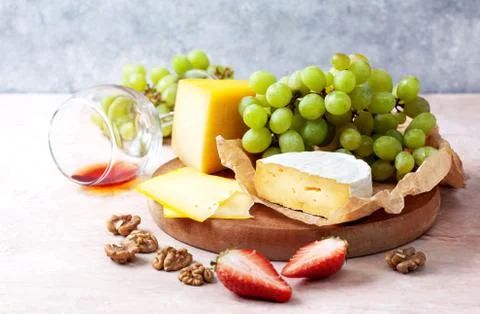Different cheeses with fruit Stock Photos