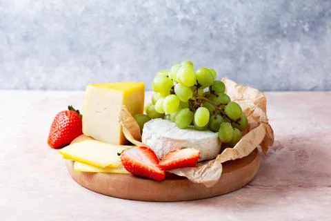 Different cheeses with fruit Stock Photos