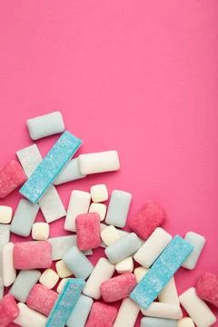 Different chewing gums on yellow background. Space for text. Vertical photo Stock Photos