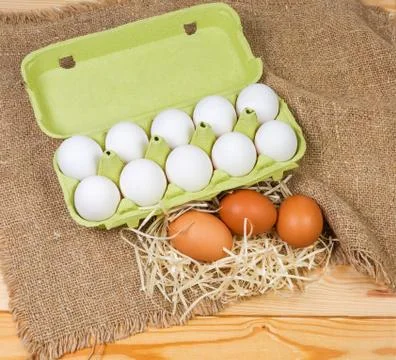 Different chicken eggs in paper pulp carton and separately Stock Photos