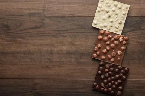 Different chocolate bars with whole hazelnuts Stock Photos