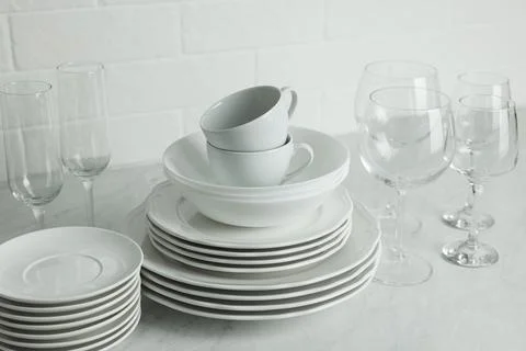 Different clean dishware, cups and glasses on countertop Stock Photos