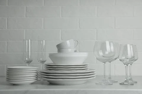 Different clean dishware, cups and glasses on countertop Stock Photos