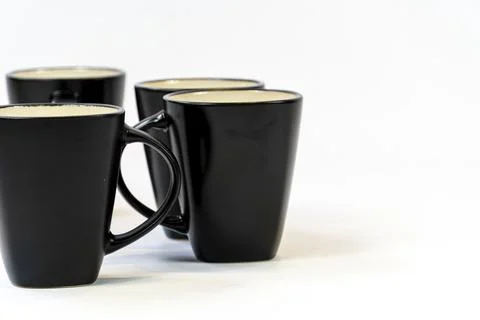 Different clean plates in dish drying rack on kitchen counter Stock Photos