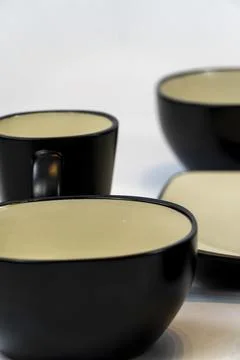 Different clean plates in dish drying rack on kitchen counter Stock Photos