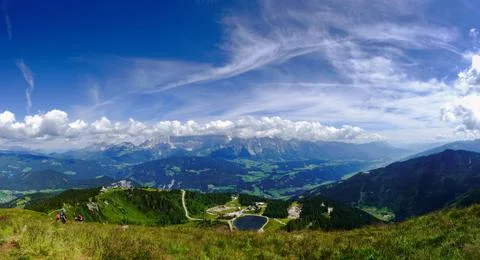 Different clouds on the blue sky while hiking in the mountains panorama Stock Photos