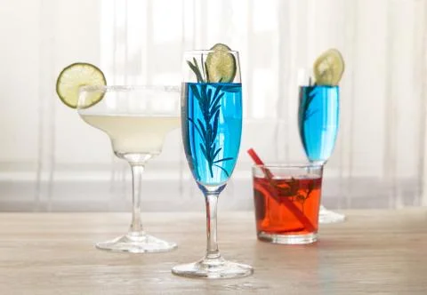 Different cocktails in front of window Stock Photos