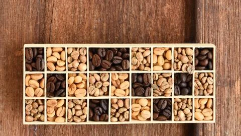 Different coffee beans in a rectangular box Stock Photos