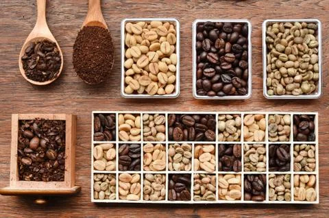 Different coffee forms in wooden box and ground coffee in wooden spoon Stock Photos