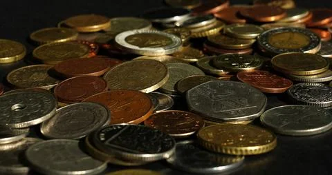 Different coins on a black background Stock Photos