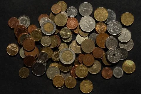 Different coins on a black background Stock Photos