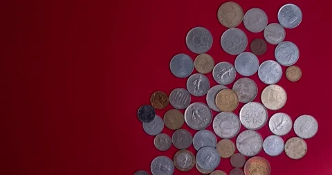 Different coins red background Stock Footage 169627405