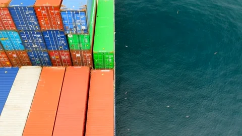 Different color containers loaded on the vessel and sea water around Stock Footage 242803412