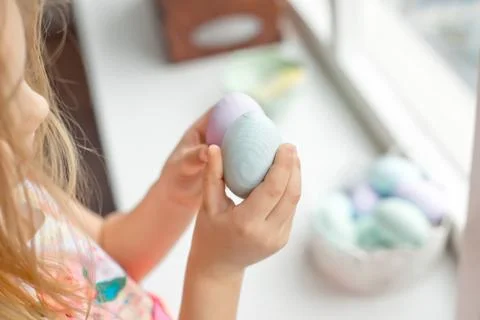 Different color Easter Eggs in a child's hands- egg hunt Stock Photos