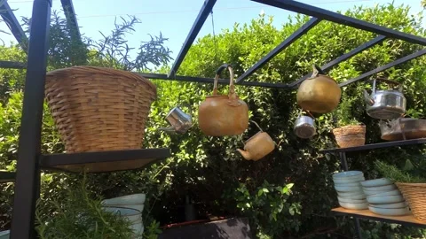 Different color, form and material teapots hanging on metal rack Stock Footage 199034420