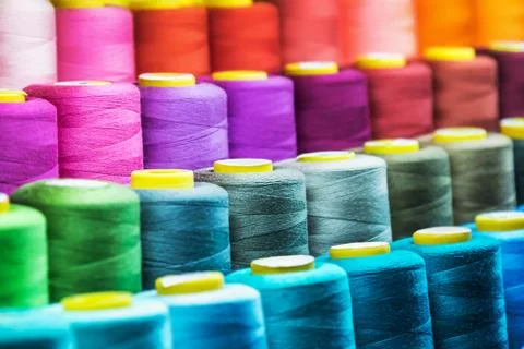 Different color spools of thread for the textile industry 스톡 사진