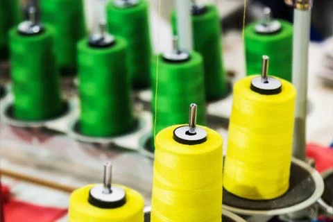 Different color spools of thread for the textile industry Stock Photos