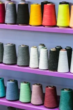 Different color spools of thread for the textile industry 库存照片
