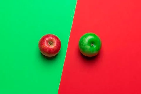 Different colored apples on a red and green desk. Above view. Diet food. Stock Photos