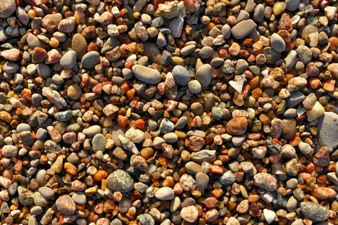 Different colored beach pebbles as background or texture. Stock Photos
