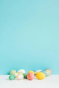 Different colored easter eggs table Stock Photos