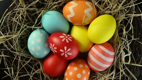 Different colored eggs spin in a nest Stock Footage 124471491