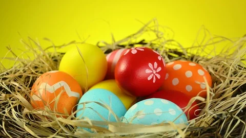 Different colored eggs spin in a nest Stock Footage 124471747
