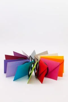 Different colored envelopes on the white desk Stock Photos