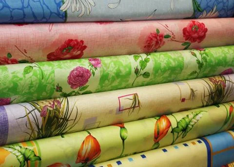 Different colored fabric in rolls Stock Photos