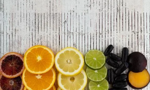 Different colored fruit on a white plank background. Copyspace. Conceptual Stock Photos