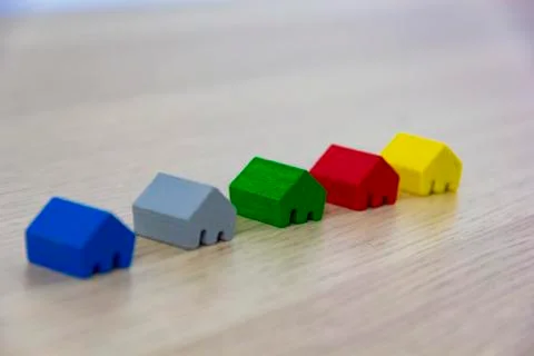Different colored game pieces representing different houses, concept of choice Stockfoto's