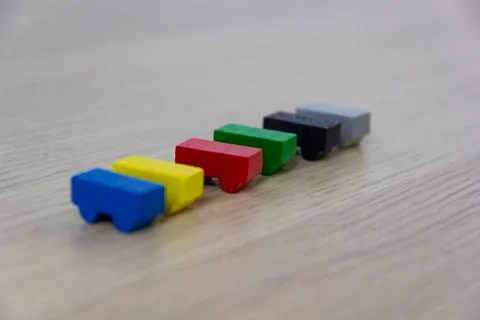Different colored game pieces representing different cars, concept of choice Stockfoto's